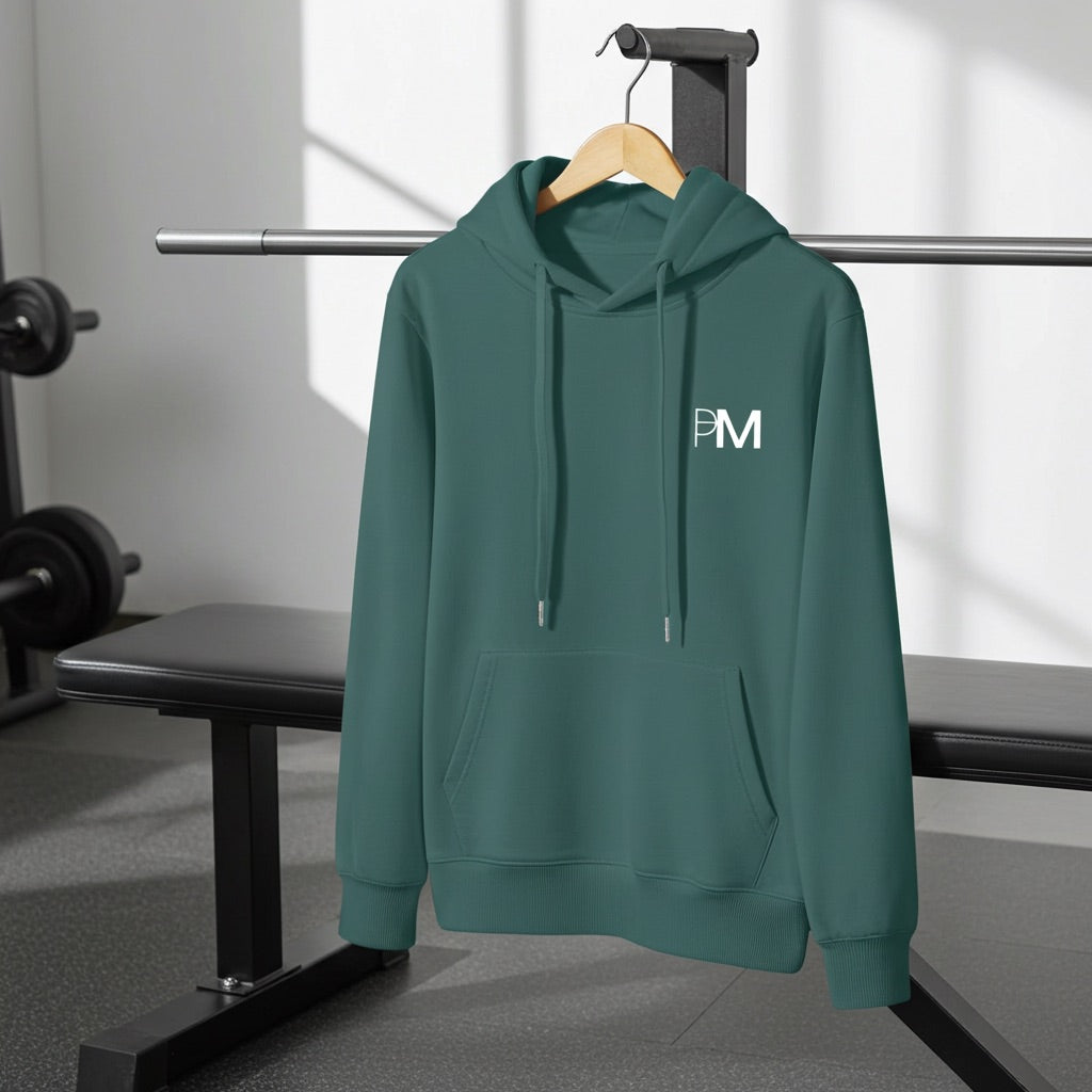 Green hoodie with a PM logo on a hanger in a gym setting